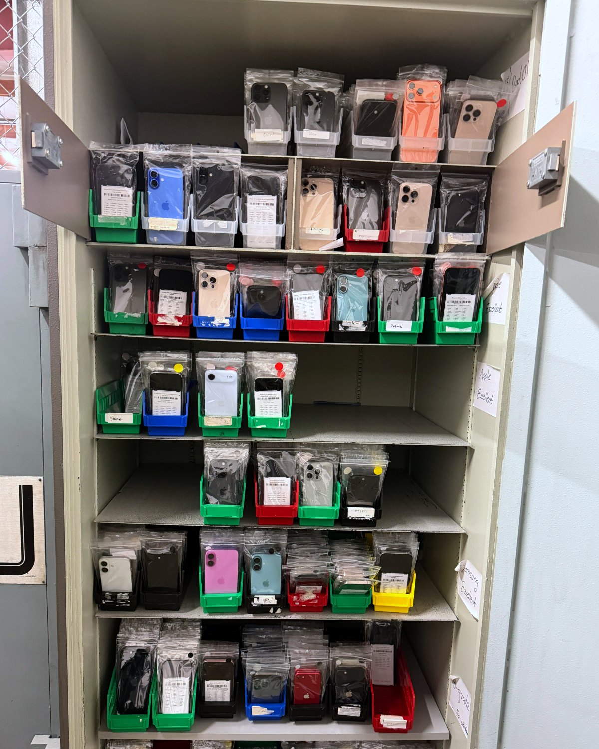 Graded phones bagged and binned by grade in the stock cabinet, ready to ship