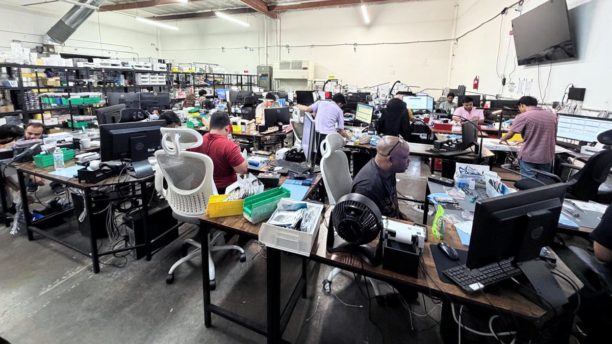 Wide view of the 2ndlifephones repair floor in El Segundo with rows of technicians at benches